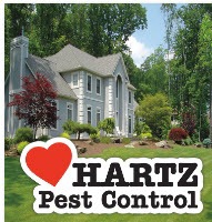 The image shows a stately home with "Hartz Pest Control" superimposed in the foreground.